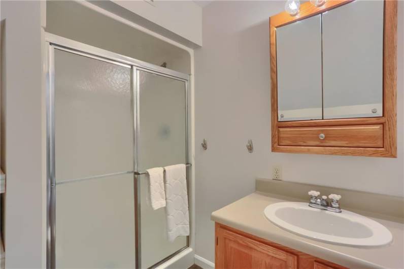 The primary bathroom has private access to this full bathroom with a shower.