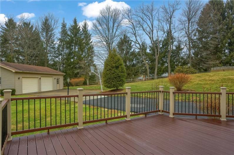 The deck leads to the lush homesite with a detached garage for all your storage needs.