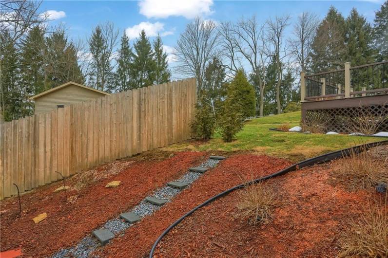 The landscaping features a stone path.