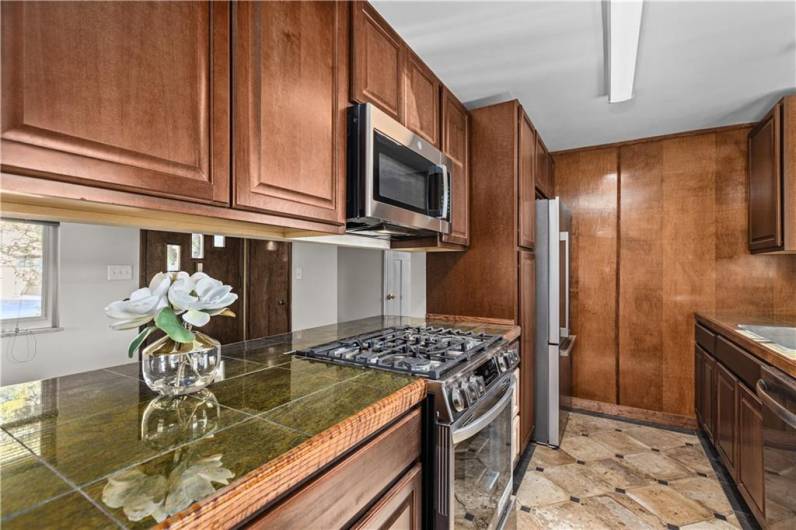 Gorgeous renovated Kitchen with new cherry cabinetry, new upgraded stainless steel appliances.  Stove is a 5 burner and convection heat!  Granite tiled countertops.  New lighting.