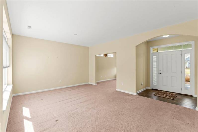 View of Living Room and Front 7x5 Arched Entryway w/ Beautiful Door offering Light Panels on both side and Above plus Ceramic Tile Entry