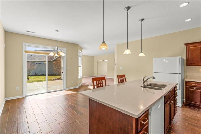 MASSIVE Eat-in Kitchen w/ Dining Area offering Sliding Glass Door to Mostly Private Backyard featuring a 15x11 Concreete Patio area