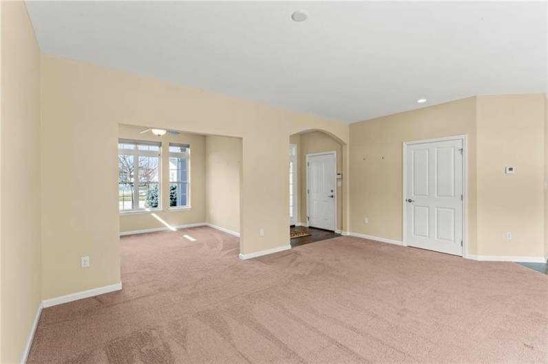 Living Rom showing Dining Room, Entrance, Coar Closet & Door to HUGE Oversized Garage w/ extra 9x4 Kickout space!