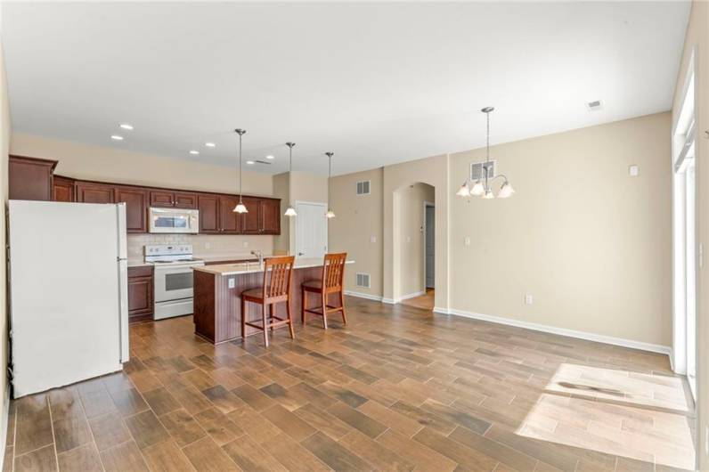 View of SPACIOUS & Open Eat-in Kitchen w/ Dining Area, Attractive Light Fixtures plus recessed Lighting.Sliding Glass Doors to Mostly Private Back 15x11 Patio area