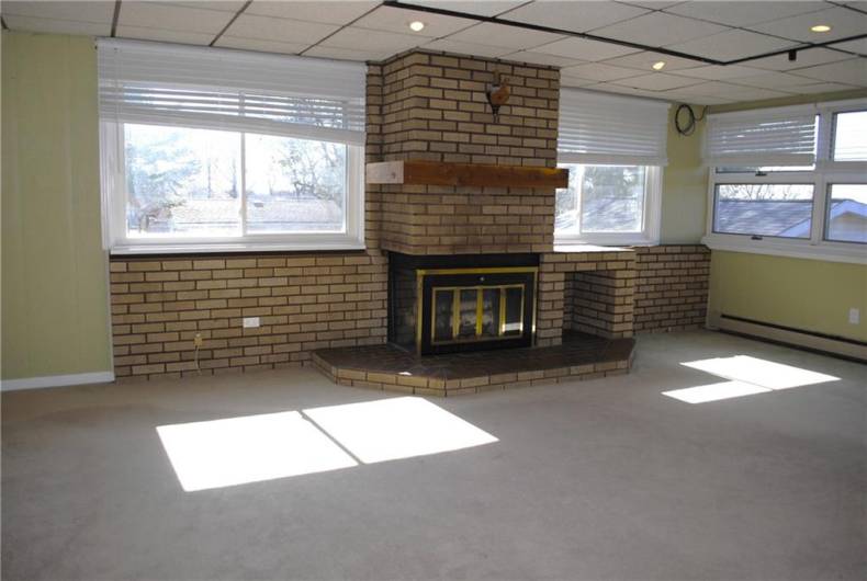 Large family room with fireplace off kitchen.  There is a large covered porch of famiy room.