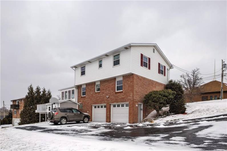 Back of home showing 2 separate garage doors!