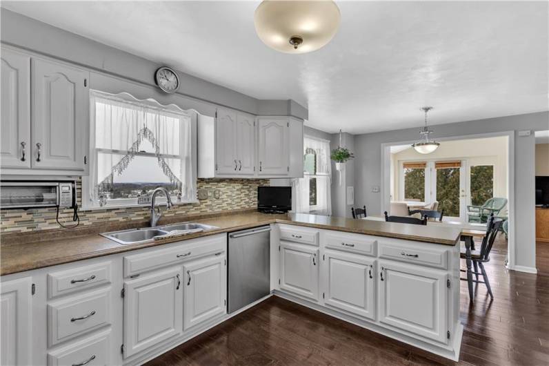 Modernized kitchen showing plenty of cabinetry & gorgeous backsplash!