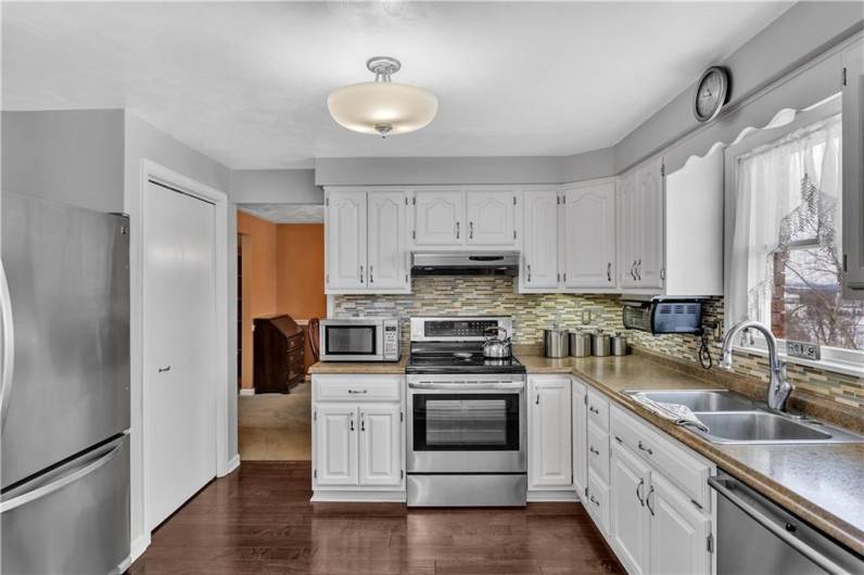 This kitchen has 2 pantries, one on either side of the included stainless steel refrigerator!