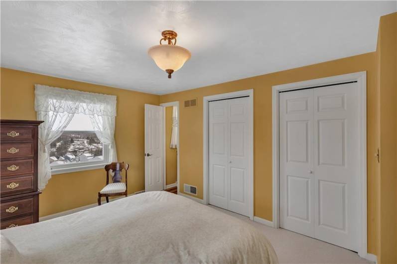 Another view of the master bedroom including en-suite full bathroom & spacious his-and-her closets!