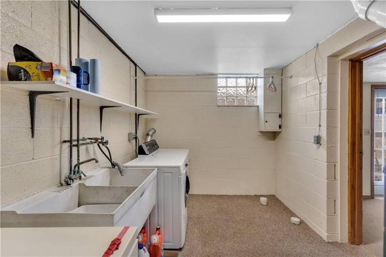 Large laundry room includes plenty of shelving, another storage room, a deep freezer & another refrigerator!