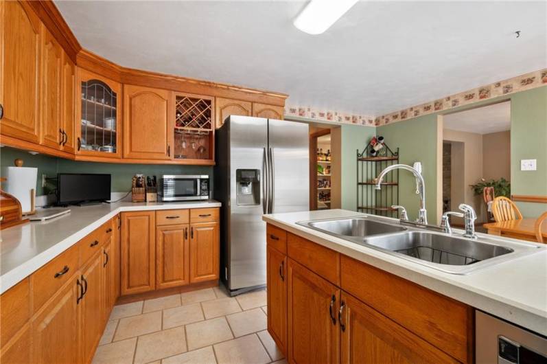 The kitchen sink comes equipped with a garbage disposal and a dishwasher.