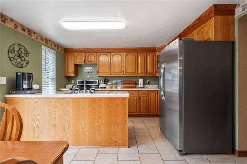 The kitchen features stainless steel appliances.