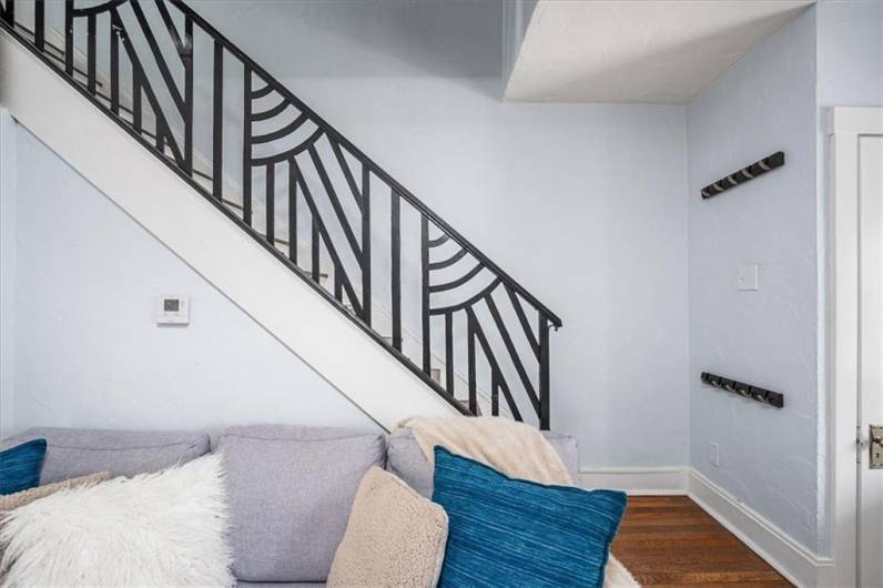 Gorgeous wrought iron stair case and hardwood floors.