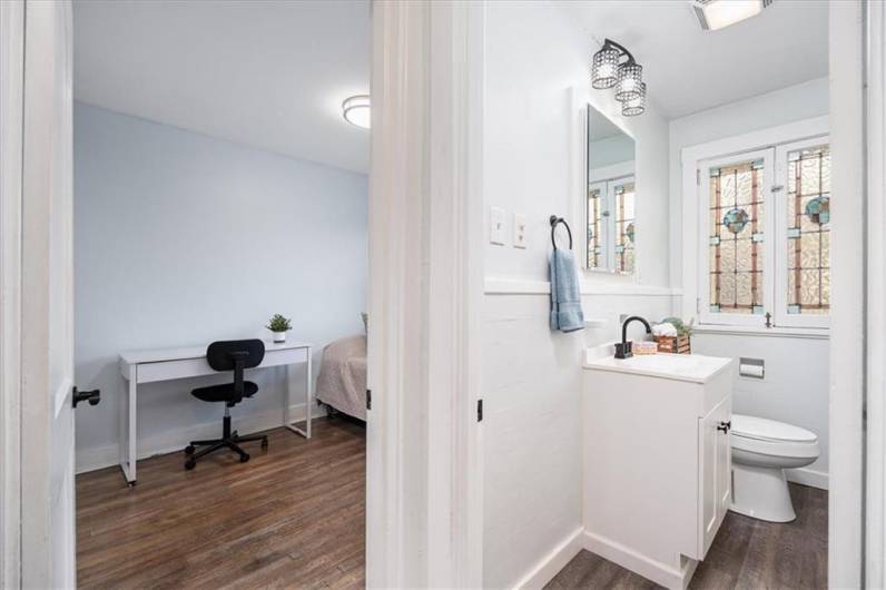 Upstairs updated bathroom with gorgeous original stained glass windows.