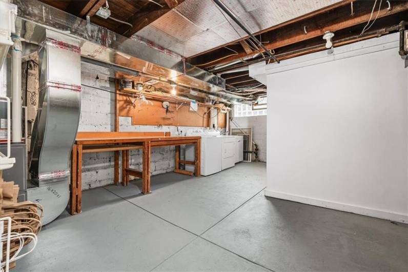 Ample laundry space in basement