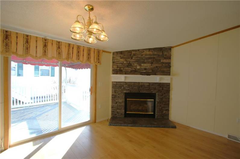 Beautiful Chandelier in 16x13 Formal Dining Room highlighted by Stacked-Stone Gas Fireplace.Sliding Glass Door to side 15x9 Covered Porch w/ Awnings