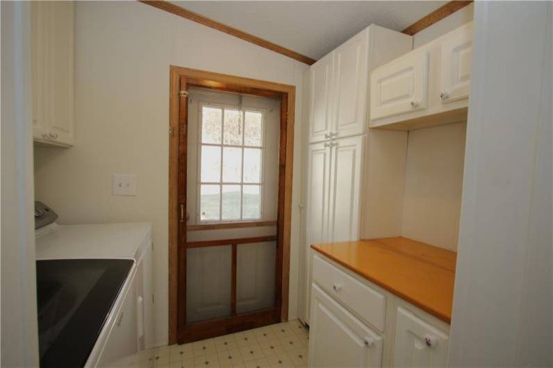 Convenient 8x7 Laundry off Kitchen and back entrance.Addional Storage Cabinets & Folding Table