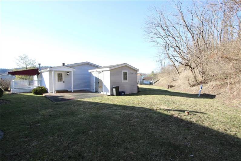 Nice Level Back Yard bordering Woods. Shed Included.