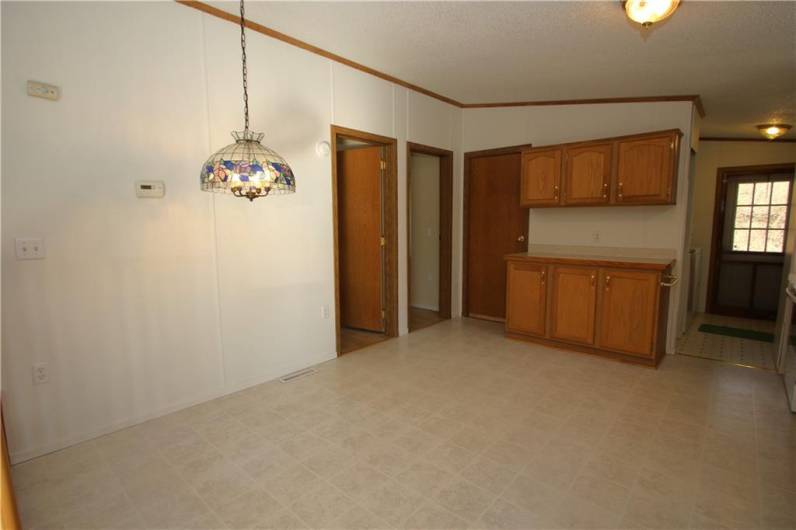 Separate Breakfast Nook / Dining area in 14x13 Eat-in Kitchen accented by Stained Glass Chandelier Plenty of Cabinetry