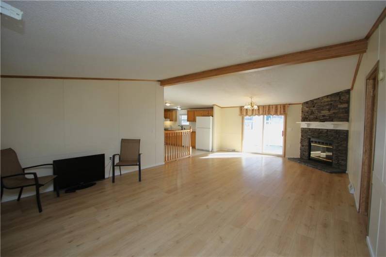 Front Entry into 16x26 Great Room boasting a Stacked-Stone Gas Fireplace w/ Wood Mantel