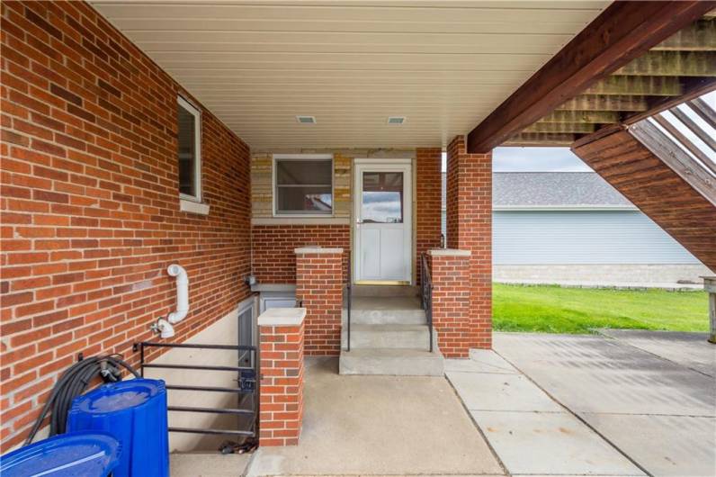 Side enterance leading to den/dining room and Basement area