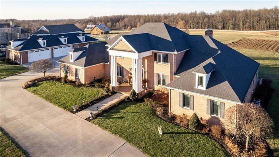 View of front of house with additional 4 Car Detached Garage in background with 10 acres of land