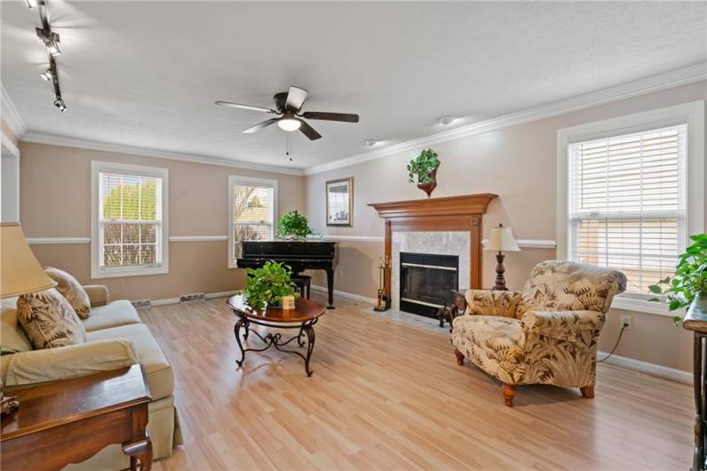 The spacious family room boasts Pergo style flooring, recessed lighting, crown molding, & a gas fireplace with rich wood stately mantle.