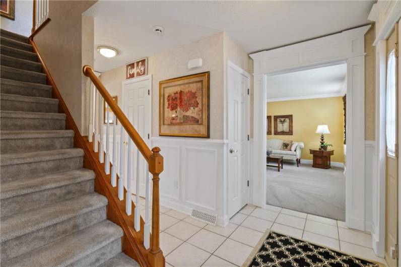 Notice the custom millwork in the inviting ceramic tiled entry.  The custom woodworking adds a classic touch of elegance.