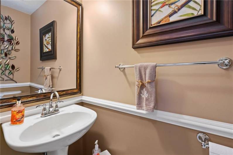 A convenient powder room is located on the main level and features new neutral paint, pedestal sink, and a new toilet.