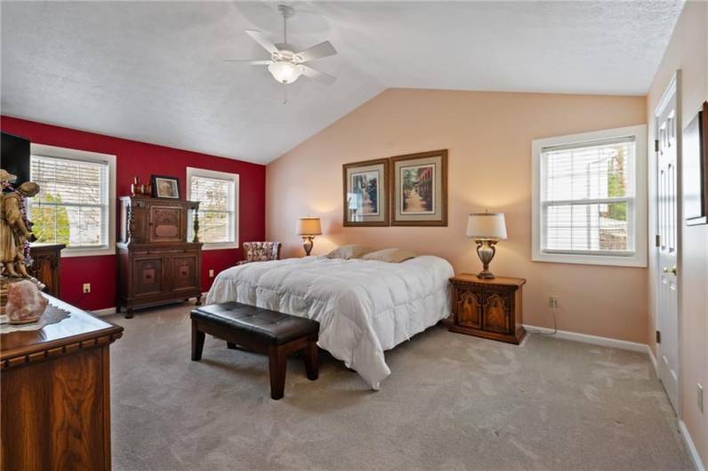 Retreat to the lush master suite complete with vaulted ceiling with lighted ceiling fan, huge walk-in closet, 3 oversized windows dressed w/2