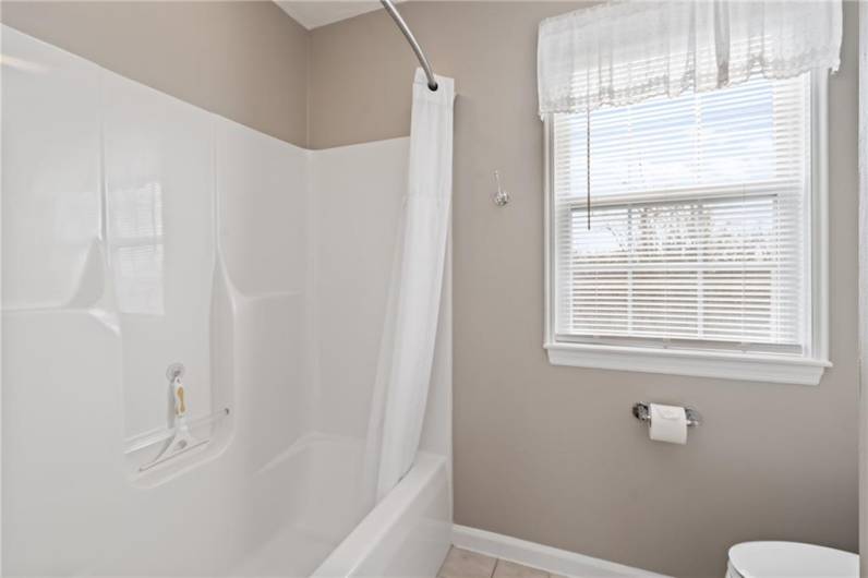 The tub/shower combination offered in the hall full bath.