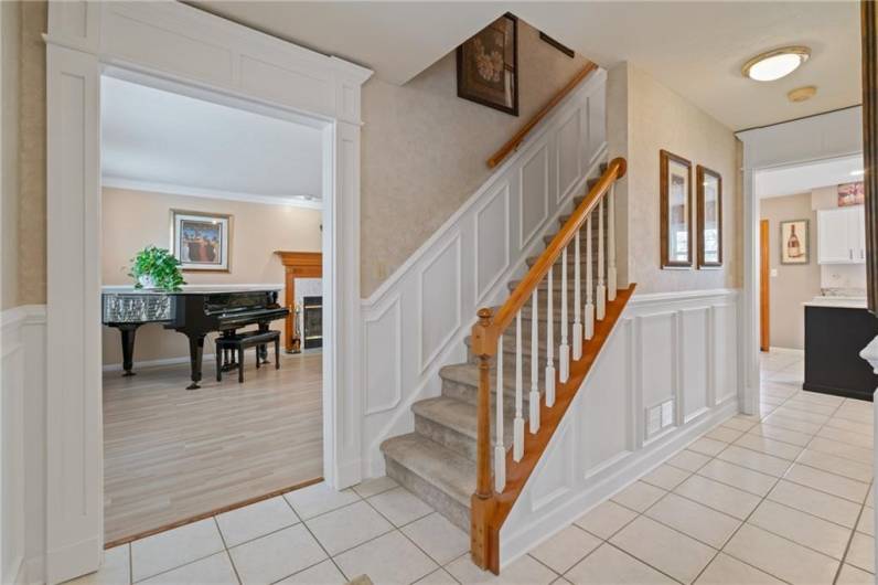 Exquisite millwork greets guests in the inviting entry.  Custom wood framing around the doors and wainscotting add a touch of elegance.