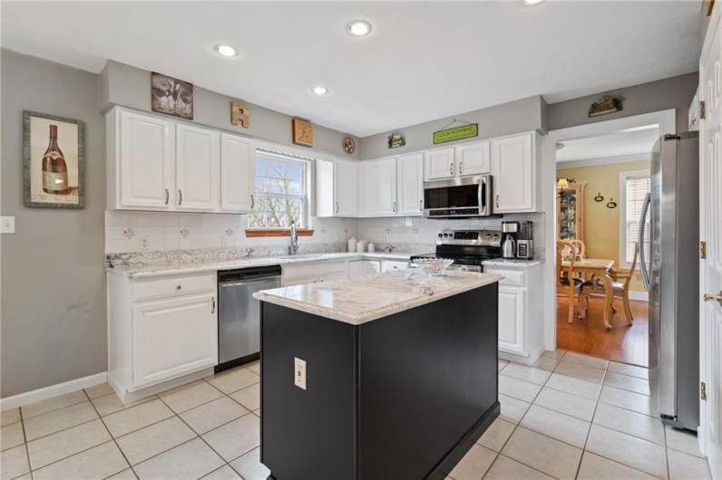 You will love the beauty and durability of the newly installed quartz countertops!  The espresso island wonderfully complements the white cabinets and ample quartz counters.