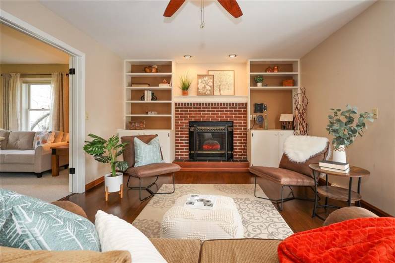 The brick fireplace has an electric insert for chilly evenings, and the built in shelves add so much character!