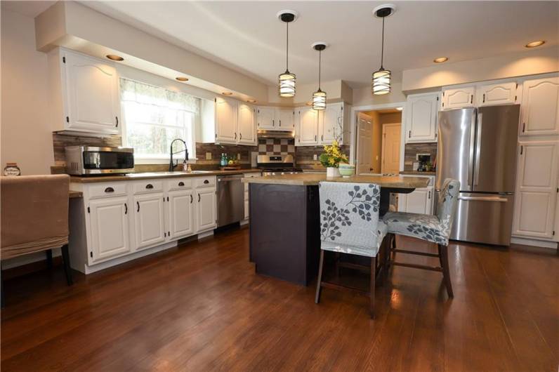 There is a pantry to the right of the refrigerator, with a large walk in pantry in the hall to the garage entrance!