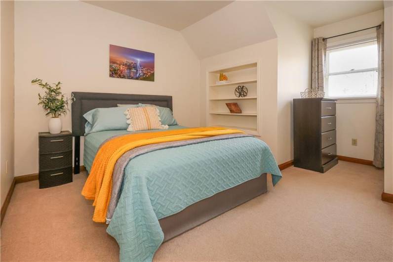 13x9 bedroom with build in shelving, large closet and extra space in the alcove