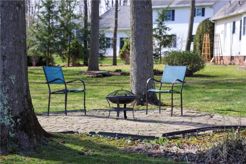 The level and semi-private backyard is accented by this stone patio and walkway from the deck.