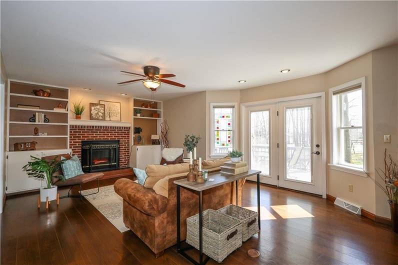 Gleaming hardwood floors reflect the outdoor light from the many windows!