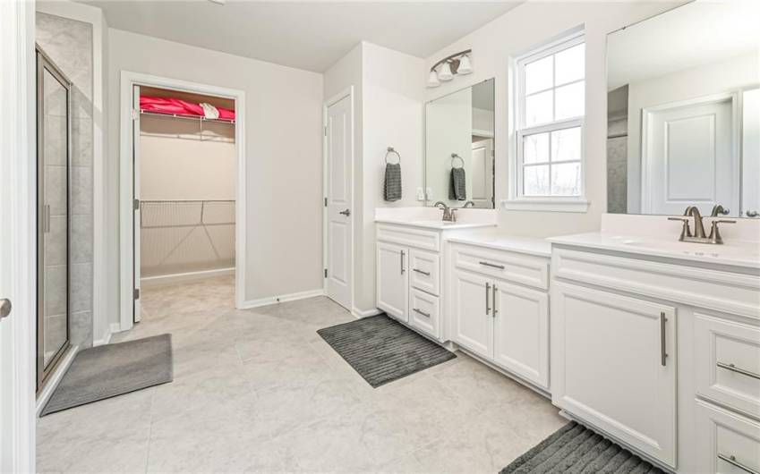 Relax in the luxury of a double vanity, Dual shower heads, second walk in closet and water closet.