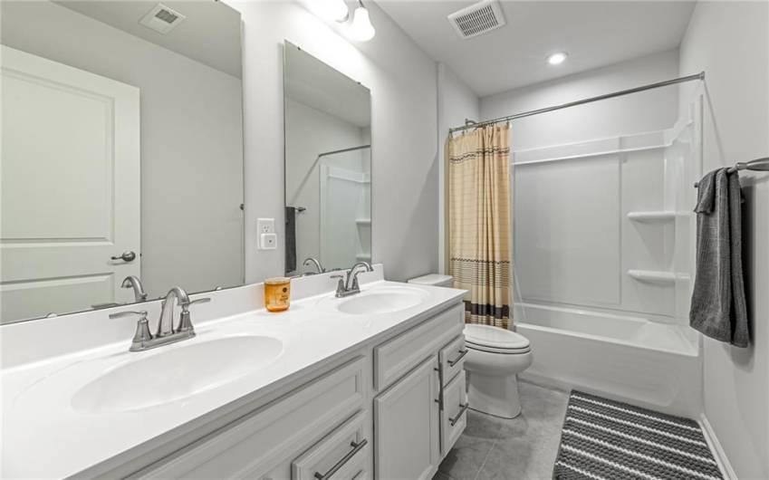 Hallway bathroom with double vanities