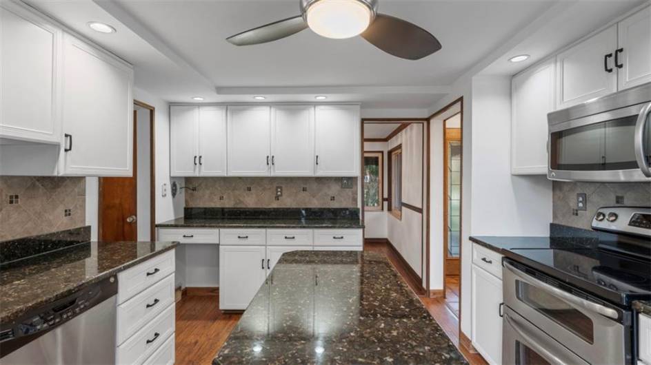 Small center island adds to the wonderful amounts of countertop and prep spaces!  Multiple chefs can cook here!