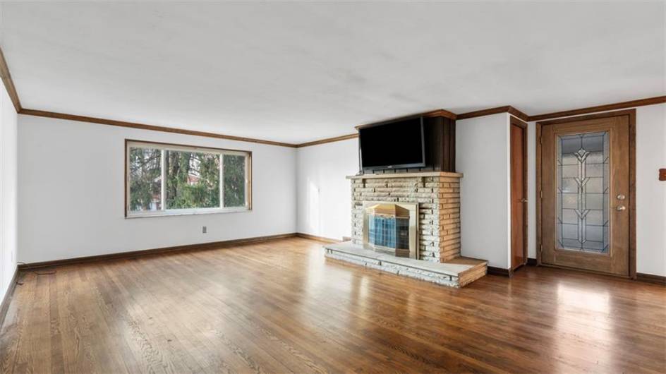 Bring your BIG SECTIONAL SOFA!!!!  there's plenty of room for it.  TV hookups already above the fireplace