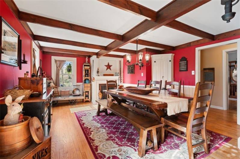 Inviting Classic charming dining room with unique built-in storage, beamed ceiling, and decorative fireplace is ideal for your holiday and family gatherings! PERFECT!