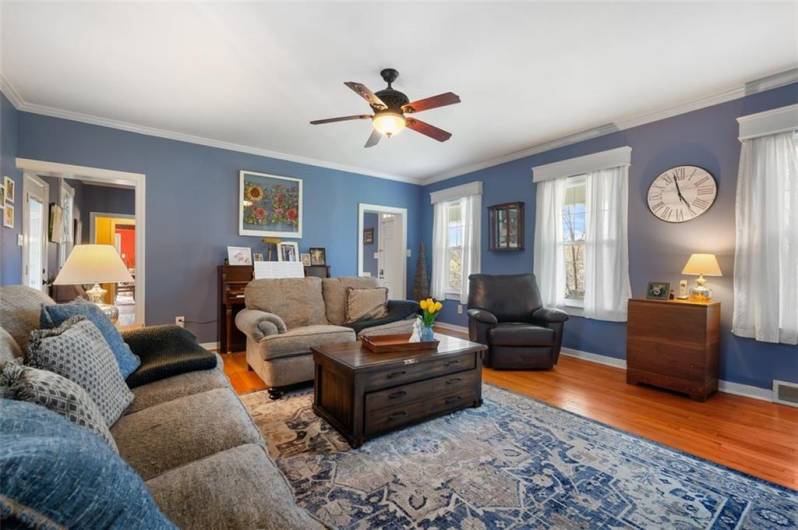 A wall of windows enhances this pleasing family room. Make yourself at home!