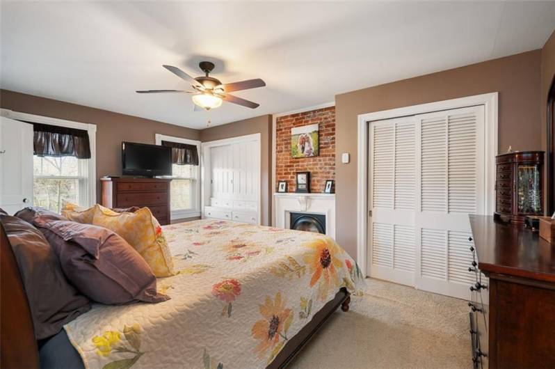 The primary bedroom is spacious with its own decorative fireplace and two huge closets.