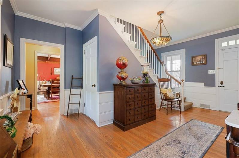 This farmhouse home has two entrances...from the front porch. Easy access into the beautiful front hallway with gleaming hardwood floors and crown moldings.
