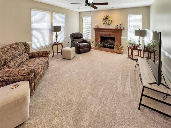 The first floor family room features a gas log fireplace.