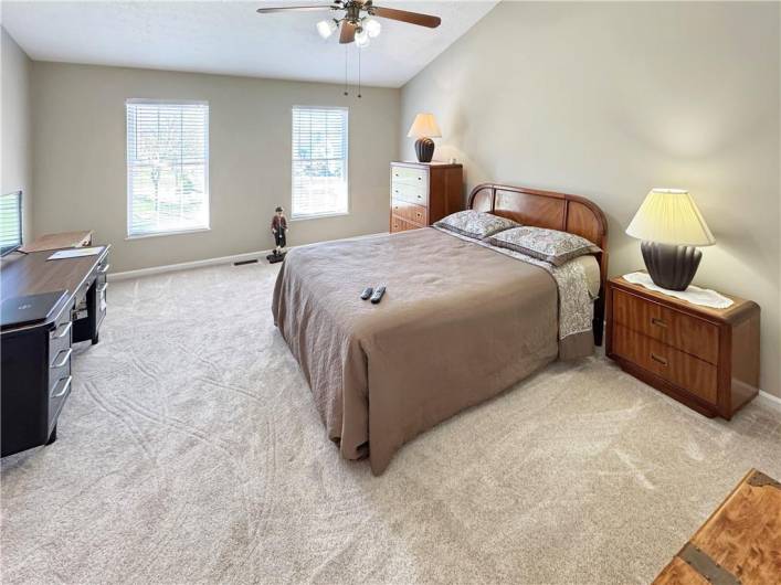 Spacious master bedroom has a vaulted ceiling.