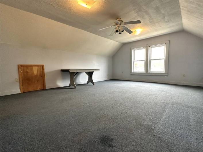Walkup attic area could be home office or storage.