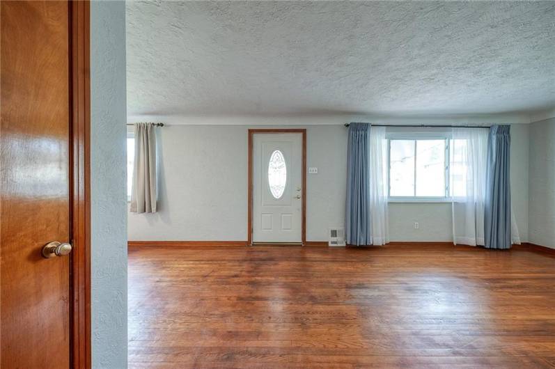 Living room with coved ceiling and hardwood floors.